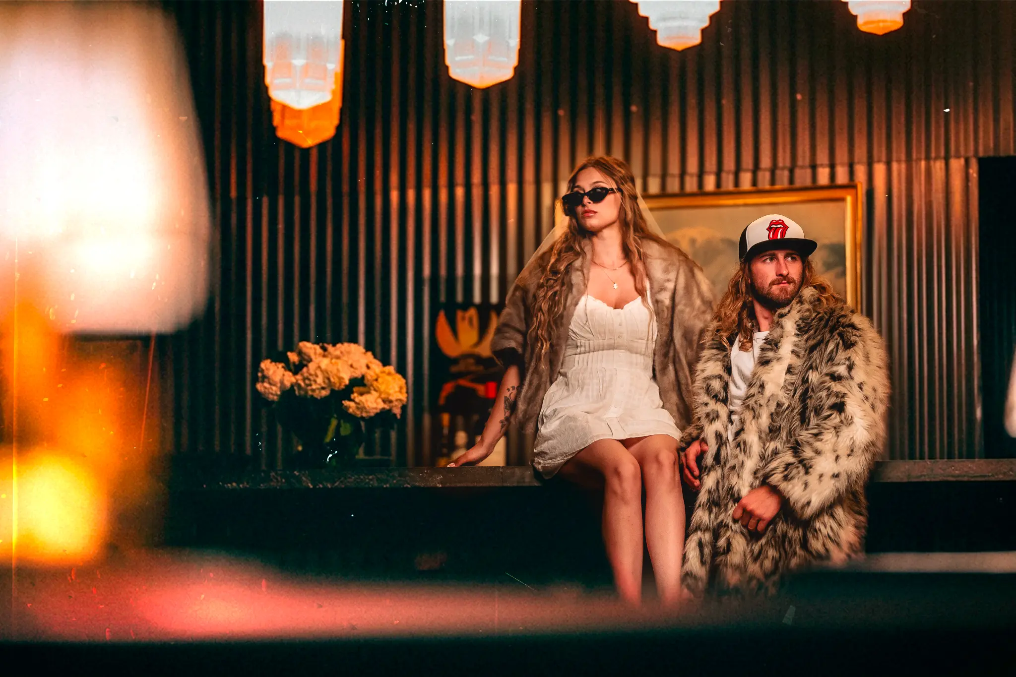 Couple in moody neon-lit industrial space